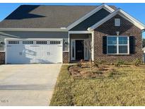 Charming single-Gathering home features a well-maintained lawn, two-car garage, and brick and vinyl siding at 1917 Darrell Dr # 5, Graham, NC 27253