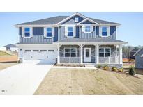 Charming two-story home with a two-car garage and inviting front porch at 525 Glenkirk Pl, Garner, NC 27529