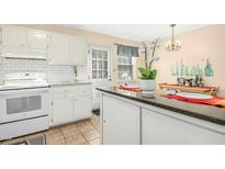 Bright kitchen features white appliances, subway tile backsplash, and a breakfast bar at 1002 Willow Dr # Apt 7, Chapel Hill, NC 27514