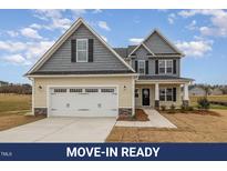 Charming two-story home featuring a two-car garage and classic architectural details at 54 Barony Ln, Smithfield, NC 27577