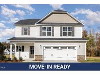 Charming two-story home with white siding, gray shutters, a two-car garage, and well-maintained landscaping at 246 Trescott St, Smithfield, NC 27577