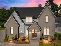Elegant two-story home with painted brick, white siding, and a charming front entrance at 701 Dartmouth Rd, Raleigh, NC 27609