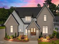 Stunning two-story home with a brick and siding exterior, complemented by lush landscaping and a welcoming entrance at 701 Dartmouth Rd, Raleigh, NC 27609