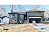 Craftsman style home with gray siding, stone accents, and a two-car garage at 240 Sequoia Dr, Louisburg, NC 27549