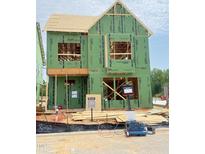 Exterior view of a new two-story home under construction with green sheathing and wood framing at 2408 Adrift Road, Fuquay Varina, NC 27526