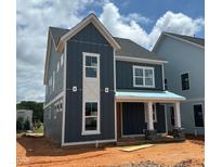 New two-story home featuring blue siding, a covered porch with stone accents and bright white window frames at 2412 Adrift Road, Fuquay Varina, NC 27526