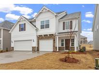 Charming two-story home with a two car garage, stone accents and a landscaped front yard at 359 N Maple Walk Dr # 210, Garner, NC 27529