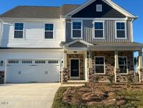 Two story home featuring a two car garage, contrasting siding colors, stone accents, and a well maintained lawn at 1923 Darrell Dr # 6, Graham, NC 27253