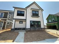 Modern two-story home featuring white siding, black trim, and a stone-accented base at 2400 Adrift Rd, Fuquay Varina, NC 27526
