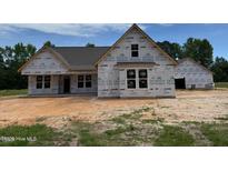 Exterior of new home construction, with OSB and housewrap, featuring attached garage at 375 Graham Rd, Cameron, NC 28326