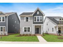 Charming two-story home with gray siding, white trim, and a well-manicured lawn at 757 Portland Rose Dr, Knightdale, NC 27545