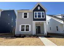 Charming two-story home with light grey siding, a covered porch, and white-trimmed windows at 757 Portland Rose Dr, Knightdale, NC 27545