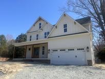 New two-story white home with an attached garage, a front porch and meticulous construction details at 113 S Ennis St, Fuquay Varina, NC 27526