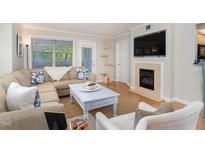 Cozy living room featuring a fireplace and comfortable seating at 1221 Westview Lane # 309, Raleigh, NC 27605