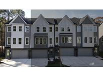 Contemporary townhouses with gray siding, white accents, and attached garages at 2126 Opulent Oaks Ln # 14, Durham, NC 27713
