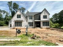 New construction home featuring a modern design with a neutral color palette and large windows at 7000 North Ridge Dr, Raleigh, NC 27615