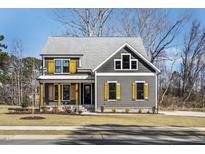 Charming two-story home with gray siding and yellow window shutters at 90 Lambert Ln, Fuquay Varina, NC 27526