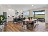 Bright, open kitchen featuring a large island, modern appliances, and an adjacent dining area with scenic views at 57 Bering Cir, Angier, NC 27501