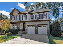 Charming two-story home with a two-car garage, landscaped yard, and craftsman-style details at 5335 Cypress Ln, Raleigh, NC 27609