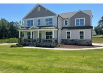 Charming two-story home with a manicured lawn and classic architectural details at 23 Quail Pt Cir, Clayton, NC 27520