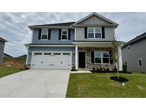 Charming two-story home with a two-car garage, stone accents, and manicured lawn at 328 Bishop Lane, Sanford, NC 27330