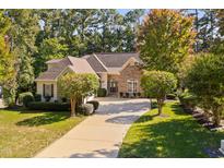 Charming single-Gathering home with a well manicured lawn, long driveway, mature trees and partial stone facade at 39 Forked Pine Ct, Chapel Hill, NC 27517
