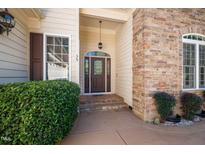 Charming front entrance featuring a stone facade, decorative glass door and meticulous landscaping at 39 Forked Pine Ct, Chapel Hill, NC 27517