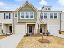 Two-story townhome with neutral siding and landscaping at 40 Lavender Ln, Clayton, NC 27520