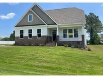 Charming two-story home with brick accents and a well-manicured lawn in a peaceful, friendly neighborhood at 52 Quail Point Cir, Clayton, NC 27520