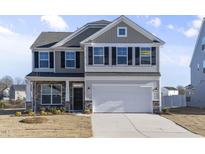 Two-story house with gray siding, white trim, and a two-car garage at 1019 Gibson House Dr, Burlington, NC 27215