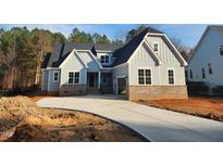 Charming two-story home featuring a light blue exterior, brick accents, and an attached two-car garage at 846 Cabin Creek Crk, Pittsboro, NC 27312