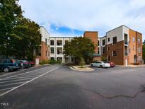 Well-maintained brick and siding condo building with ample parking and mature landscaping at 1001 Hillsborough St # 304, Raleigh, NC 27603