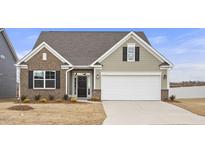 Brick and siding one-story house with a two-car garage and landscaping at 1539 Peabody Ct, Mebane, NC 27302