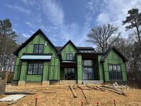 Modern two-story home with black trim being built featuring ample windows and a gabled roof at 504 Colvard Woods Way Way, Durham, NC 27713