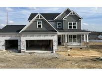 Two-story home with gray siding, a two-car garage, and a front porch at 202 Golden Leaf Farms Rd, Angier, NC 27501