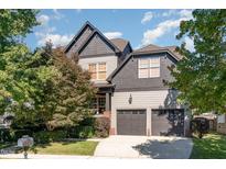 Charming two-story home with a two-car garage, mature trees, and a well-manicured lawn at 3009 Gentle Breezes Ln, Raleigh, NC 27614