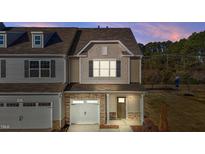Two-story townhome with gray and beige siding, stone accents, and a two-car garage at 804 Pryor St # 49, Mebane, NC 27302
