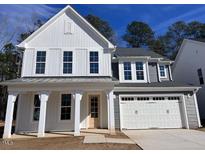 Beautiful two-story home with vertical siding, gray accents and a two car garage at 9148 Dupree Meadow Dr # 11, Angier, NC 27501