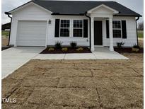 Charming single-story home with white siding, black shutters, and a freshly laid lawn at 111 Johnson Ridge Way, Four Oaks, NC 27524