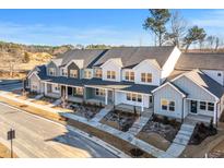 New townhouses with gray and green exterior, front porches, and landscaping at 3939 Willow Gate Way, Knightdale, NC 27604