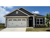 Beautiful home featuring a stone facade and a white garage door with decorative hardware at 214 Drayton Hall Ln, Sanford, NC 27330