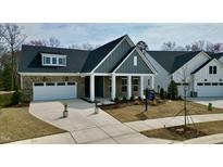 Charming single-story home features a brick facade, gray siding, and a well-manicured lawn at 2209 Abbeyhill Dr # 118, Raleigh, NC 27610