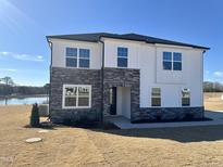 Two-story home with stone accents and a large yard at 225 Bering Cir, Angier, NC 27501
