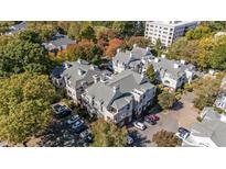 Stunning aerial view of gray apartments surrounded by colorful trees, showcasing the community and convenient parking at 1001 Brighthurst Dr # 204, Raleigh, NC 27605