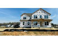 Two story new construction home with visible house wrap and window openings at 111 Demascus Way # 021, Four Oaks, NC 27524