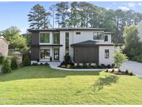 Stunning two-story home with modern design, manicured lawn, and elegant landscaping at 662 Manchester Dr, Raleigh, NC 27609