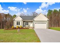 Charming single-story home with a two-car garage, well-maintained lawn, and inviting front entrance at 9314 Turkey Way, Middlesex, NC 27557