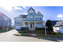 Beautiful two-story home with a charming porch and well-manicured landscaping at 2024 Stanchion St, Haw River, NC 27258