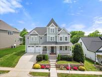 Charming two-story home features a welcoming front porch and well-manicured landscaping at 2024 Stanchion St, Haw River, NC 27258