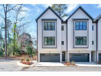 Charming townhome with a modern design, gray trim and a spacious two-car garage at 811 Maple Berry Ln # 106, Raleigh, NC 27607